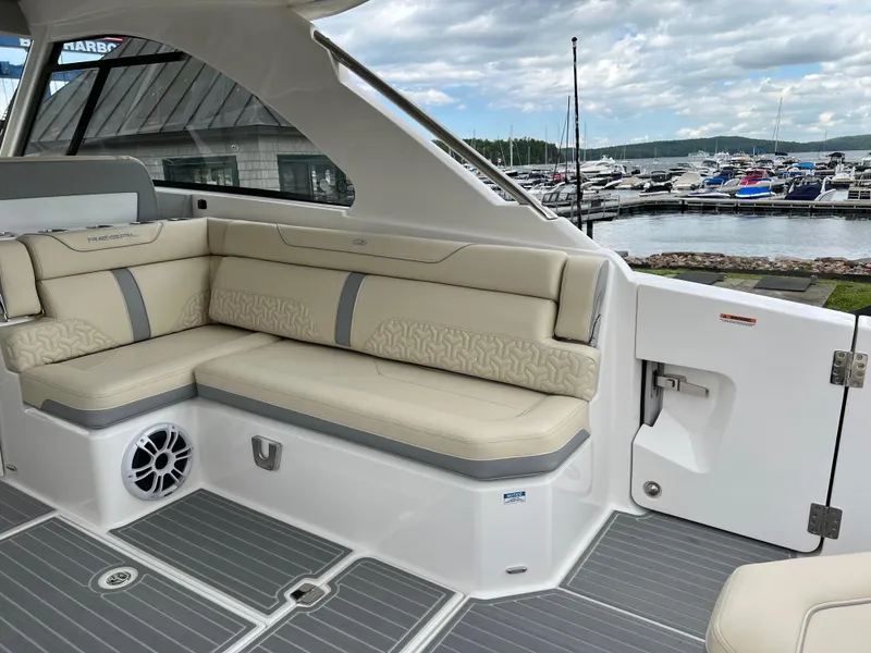 Slide: The Image of Luxurious 2022 Regal LS36 boat interior with beige seating at marina. - 36
