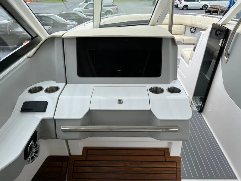 Slide: The Image of 2022 Regal LS36 boat interior with sleek dashboard and cup holders. - 39