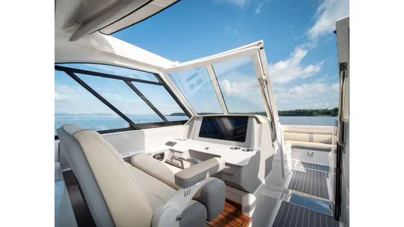 Slide: The Image of Interior of 2022 Regal LS36 boat with modern helm and seating, under blue sky. - 4
