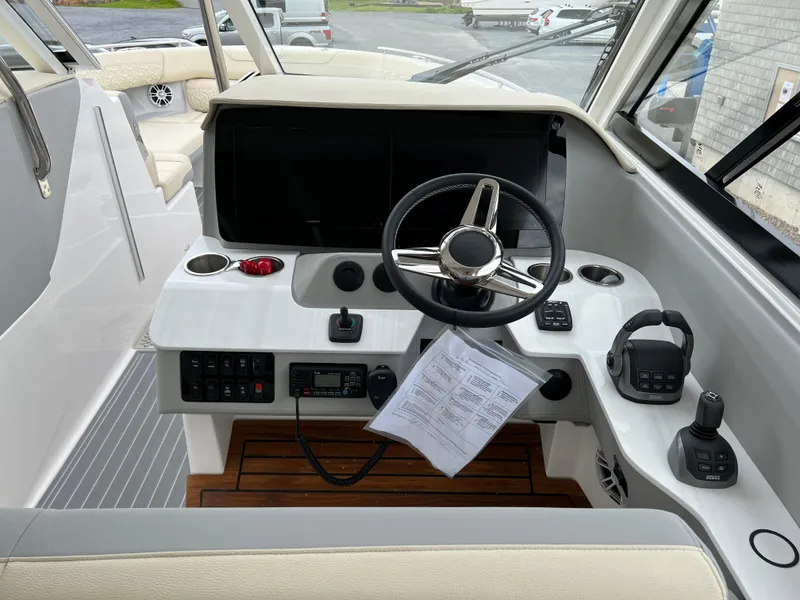 Slide: The Image of 2022 Regal LS36 boat cockpit with steering wheel and control panel. - 40