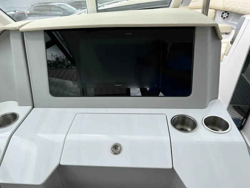 Slide: The Image of 2022 Regal LS36 boat dashboard with screen and cup holders. - 46