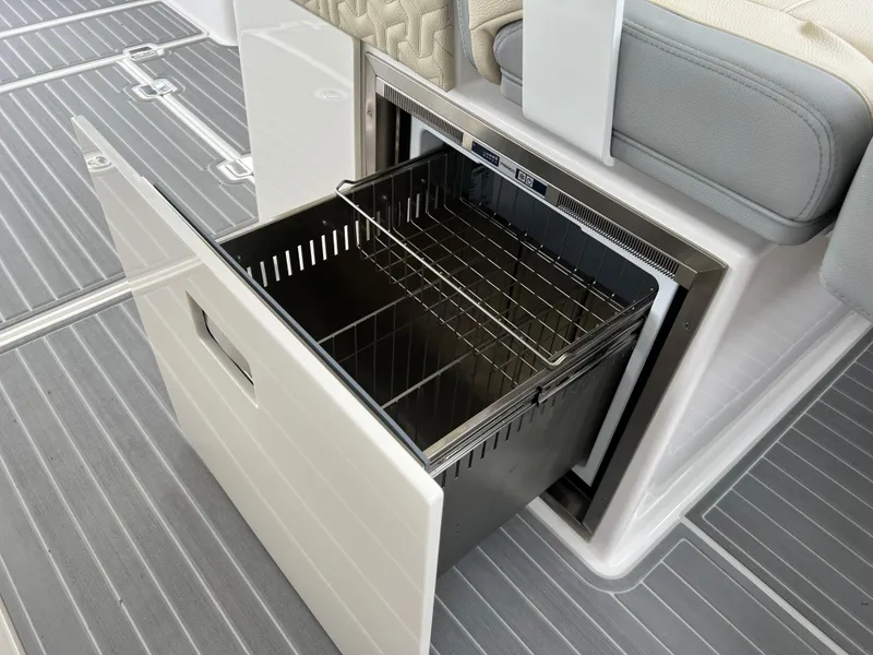 Slide: The Image of 2022 Regal LS36 boat with open storage compartment and wire basket. - 49