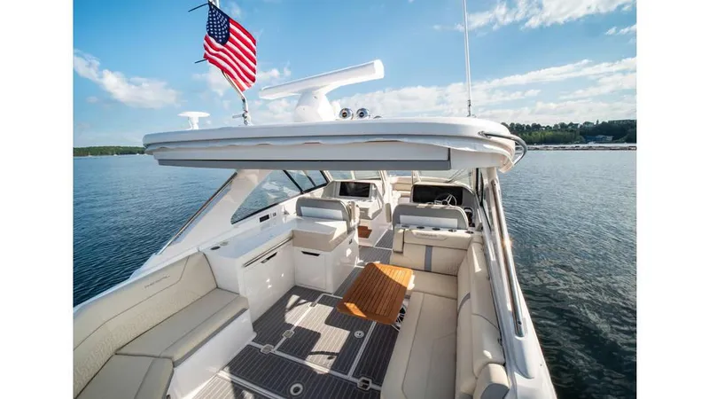 Slide: The Image of 2022 Regal LS36 boat interior with American flag on a sunny day. - 6