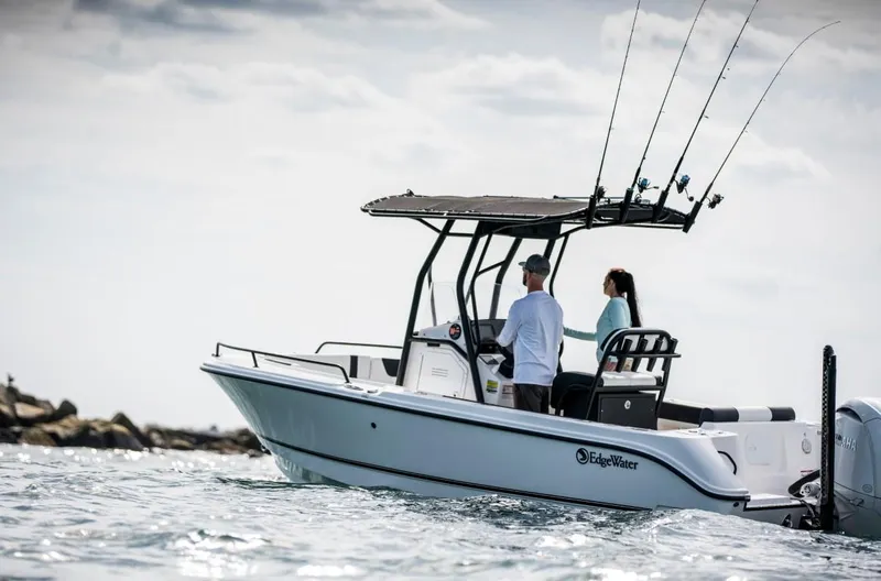 Slide: The Image of 2025 Edgewater 208CC Watchman boat on water with fishing rods. - 1