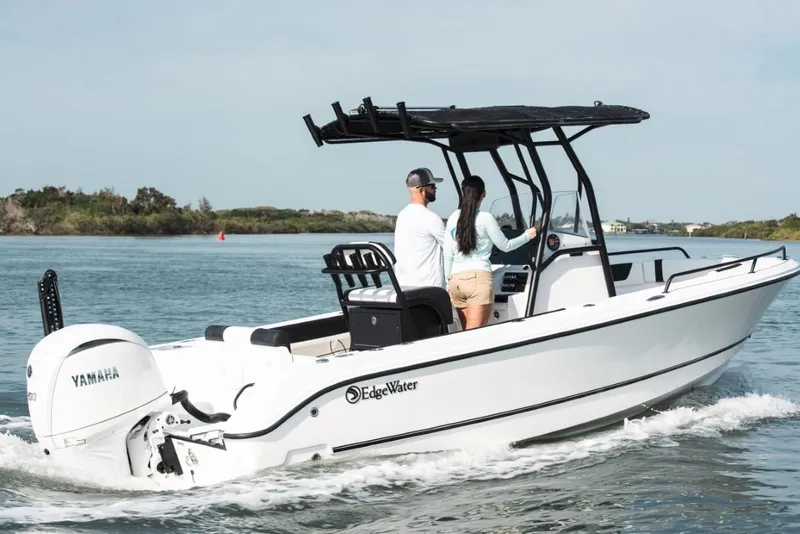 Slide: The Image of 2025 Edgewater 208CC Watchman boat cruising on a calm waterway. - 6