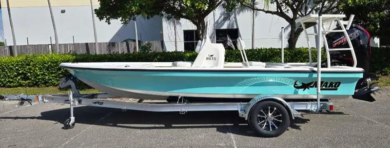 Slide: The Image of 2025 Mako 18 LTS boat on trailer, parked outdoors. - 0