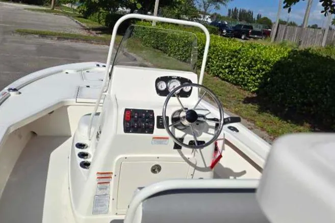 Slide: The Image of 2025 Mako 18 LTS boat interior with steering wheel and control panel. - 5