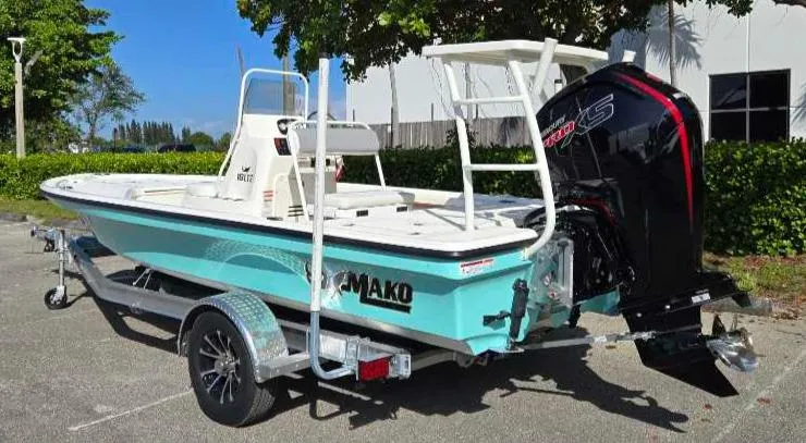 Slide: The Image of 2025 Mako 18 LTS boat on trailer, featuring powerful outboard motor. - 7