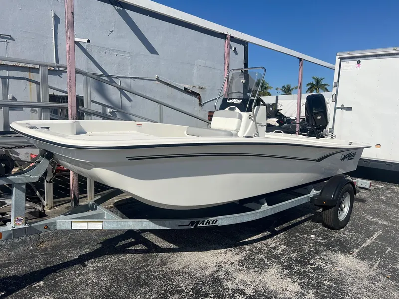 The Image of 2025 Mako Pro Skiff 15 CC boat on trailer, parked outdoors. - 0