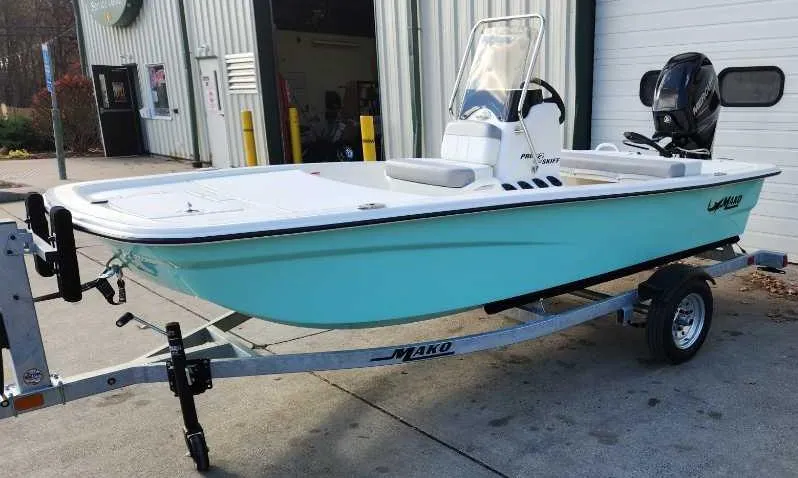 The Image of 2025 Mako Pro Skiff 13 CC boat on trailer, parked outdoors. - 0