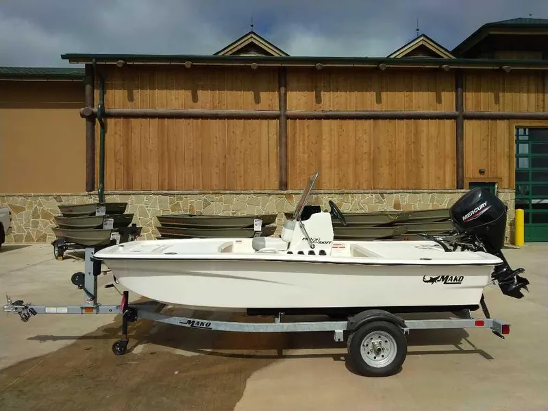 The Image of 2025 Mako Pro Skiff 13 CC boat on trailer, parked outdoors. - 0