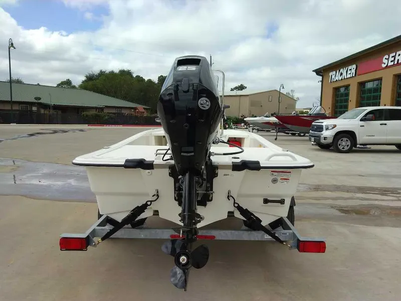 Slide: The Image of 2025 Mako Pro Skiff 13 CC boat on trailer, outdoor dealership setting. - 3