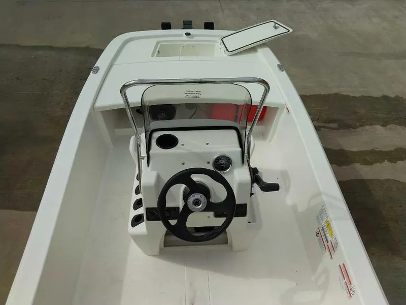 Slide: The Image of 2025 Mako Pro Skiff 13 CC boat interior with steering wheel and console. - 4
