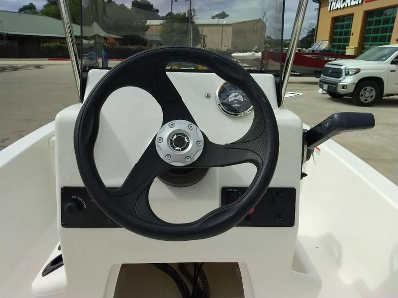 Slide: The Image of 2025 Mako Pro Skiff 13 CC steering console with black wheel and gauge. - 5