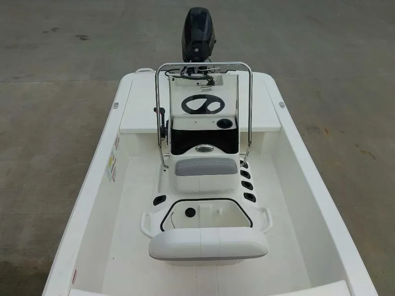 Slide: The Image of 2025 Mako Pro Skiff 13 CC boat interior with steering console and seating. - 6