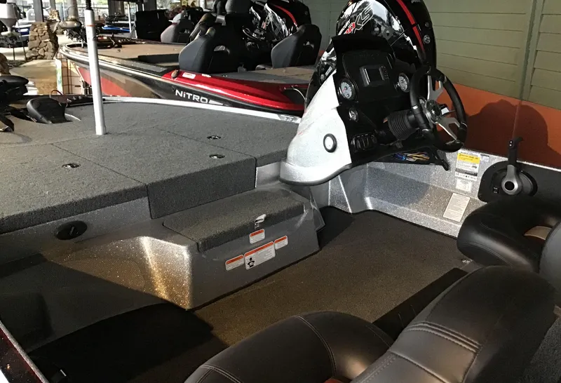 Slide: The Image of 2025 Nitro Z17 boat interior with steering console and seating area. - 2