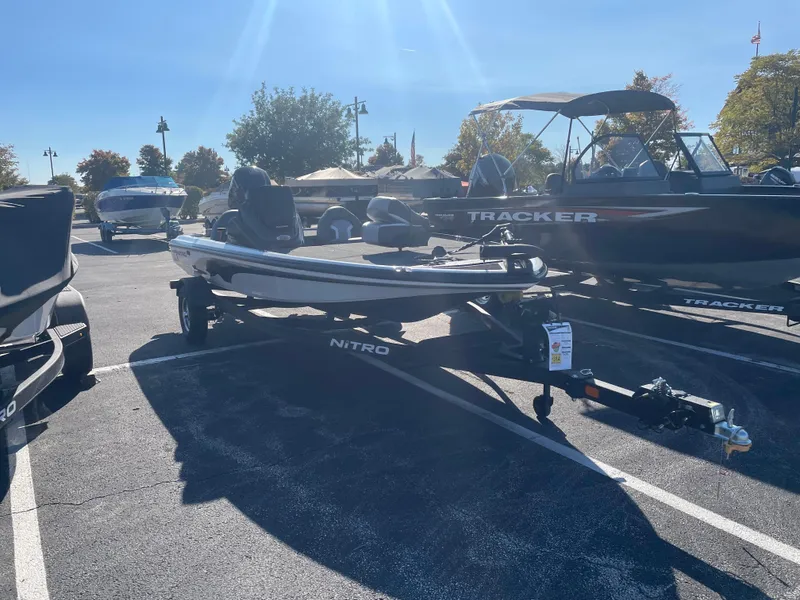 Slide: The Image of 2025 Nitro Z17 boat in parking lot, surrounded by other boats under clear blue sky. - 2