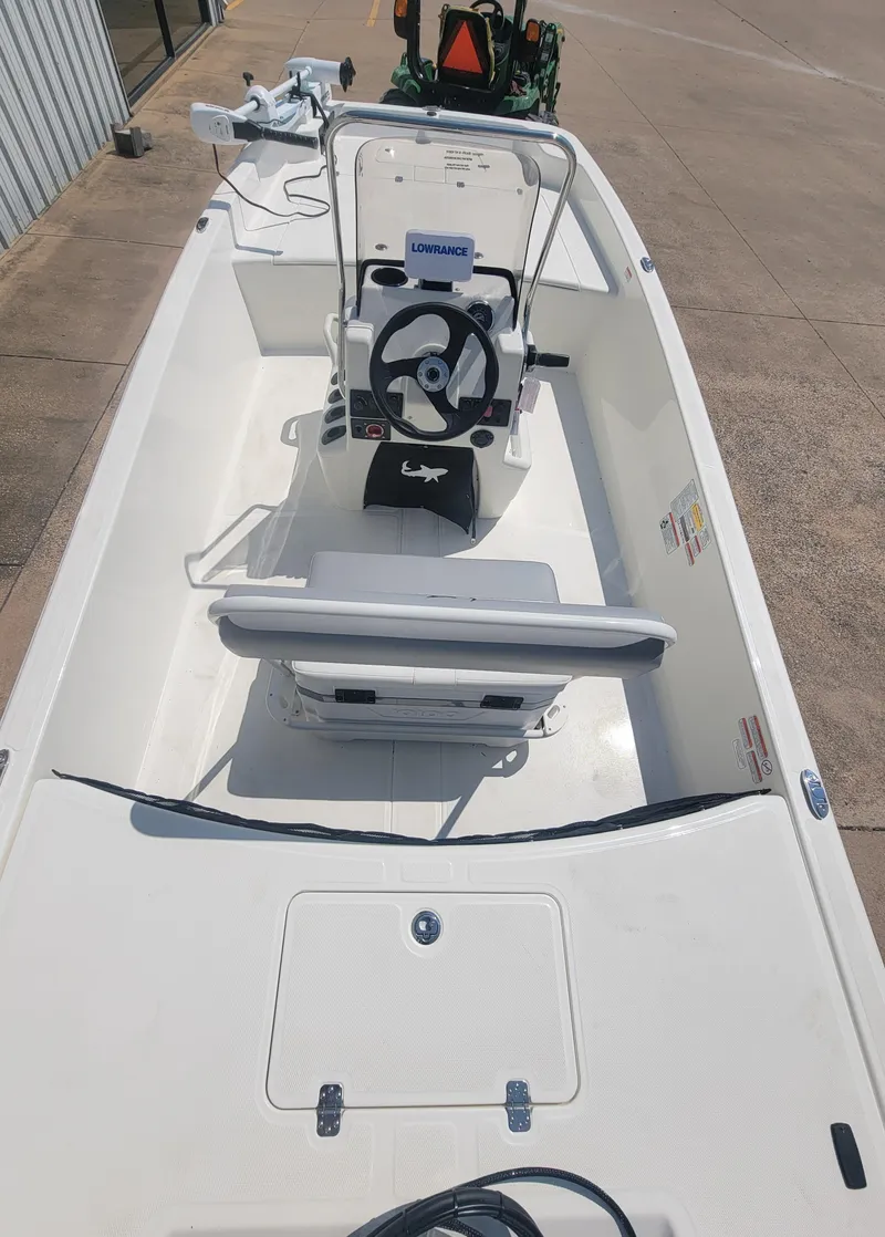 Slide: The Image of 2025 Mako Pro Skiff 17 CC boat interior with steering console and seating. - 2