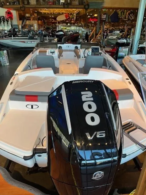 Slide: The Image of 2025 Tahoe T21 boat with Mercury 200 V6 engine displayed in showroom. - 2
