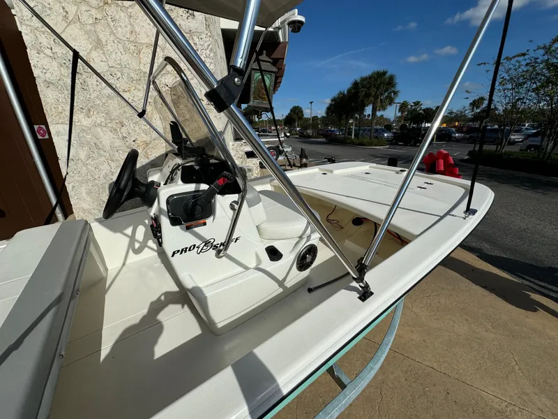 Slide: The Image of 2025 Mako Pro Skiff 13 CC boat, white interior, parked outdoors on a sunny day. - 3