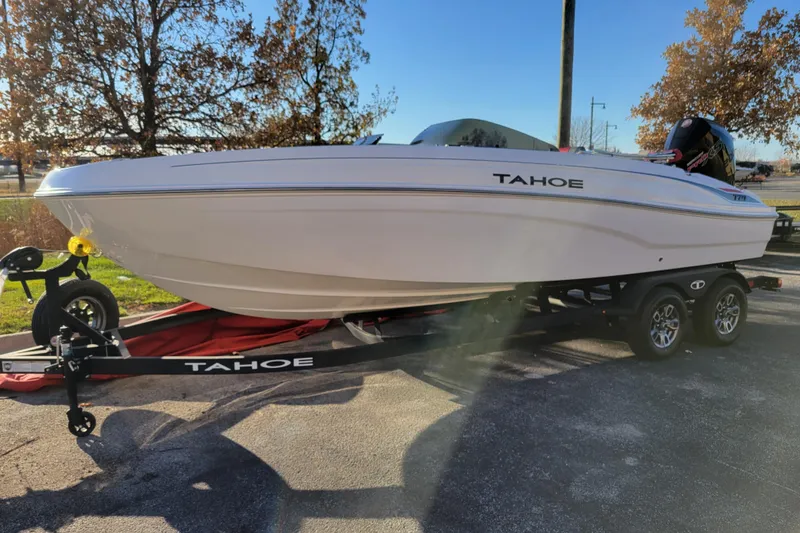 Slide: The Image of 2025 Tahoe T21 boat on trailer, parked outdoors, showcasing sleek design and modern features. - 70