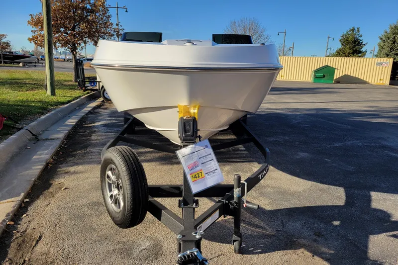 Slide: The Image of 2025 Tahoe T21 boat on trailer in parking lot, sunny day. - 75