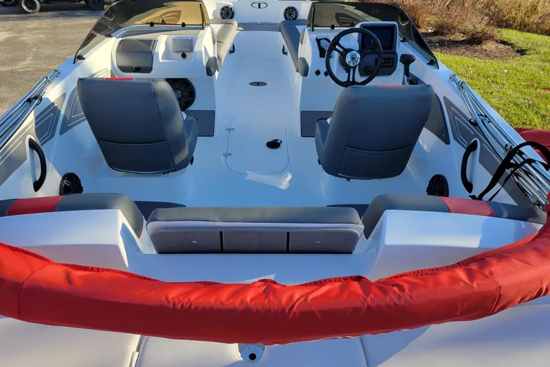 Slide: The Image of 2025 Tahoe T21 boat interior with dual seats, steering wheel, and modern dashboard. - 76
