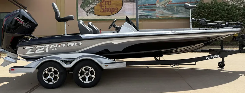 Slide: The Image of 2025 Nitro Z21 XL boat on trailer, sleek design, dual seats, outdoor display. - 1