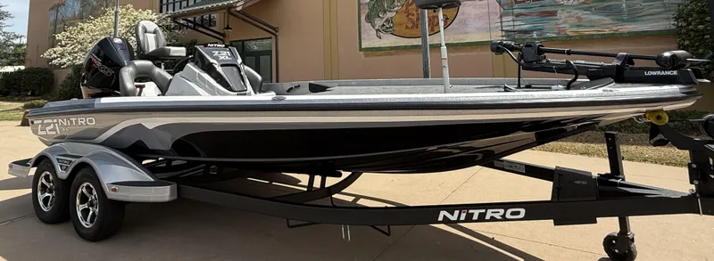 Slide: The Image of 2025 Nitro Z21 XL boat on trailer, sleek design, parked outdoors. - 5