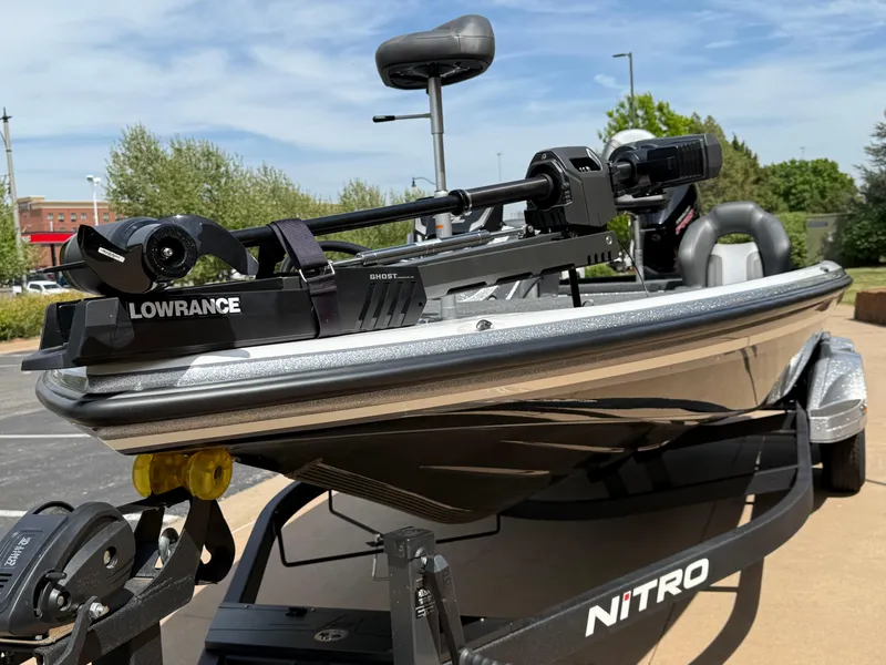 Slide: The Image of 2025 Nitro Z21 XL boat with Lowrance equipment on a trailer, parked outdoors. - 6