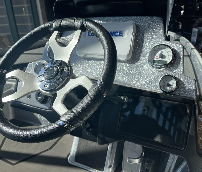 Slide: The Image of Steering wheel and dashboard of 2025 Nitro Z21 XL boat, featuring modern gauges and controls. - 8