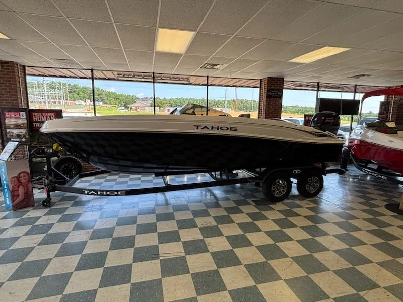 Slide: The Image of 2025 Tahoe T21 boat displayed indoors on a trailer. - 1