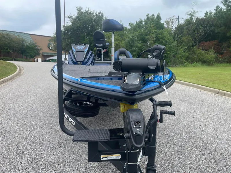Slide: The Image of 2025 Nitro Z21 XL boat on a trailer, parked on a road. - 3