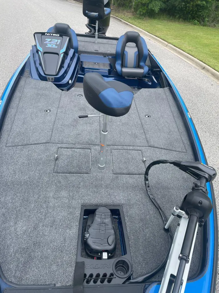 Slide: The Image of 2025 Nitro Z21 XL boat with blue and gray seating, spacious deck, and advanced controls. - 4
