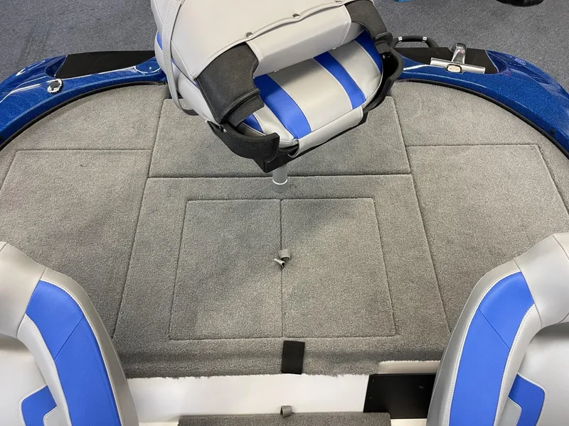 Slide: The Image of 2025 Nitro Z18 boat interior with gray and blue seating and carpeted deck. - 12