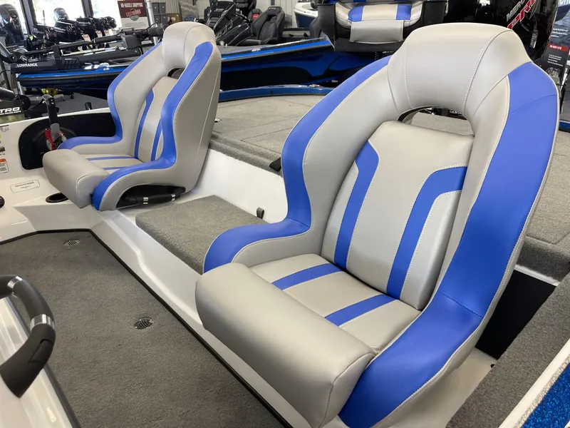Slide: The Image of 2025 Nitro Z18 boat seats with blue and gray upholstery in a showroom. - 6