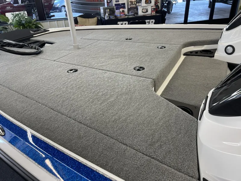 Slide: The Image of 2025 Nitro Z18 boat deck with gray carpeting and storage compartments. - 7