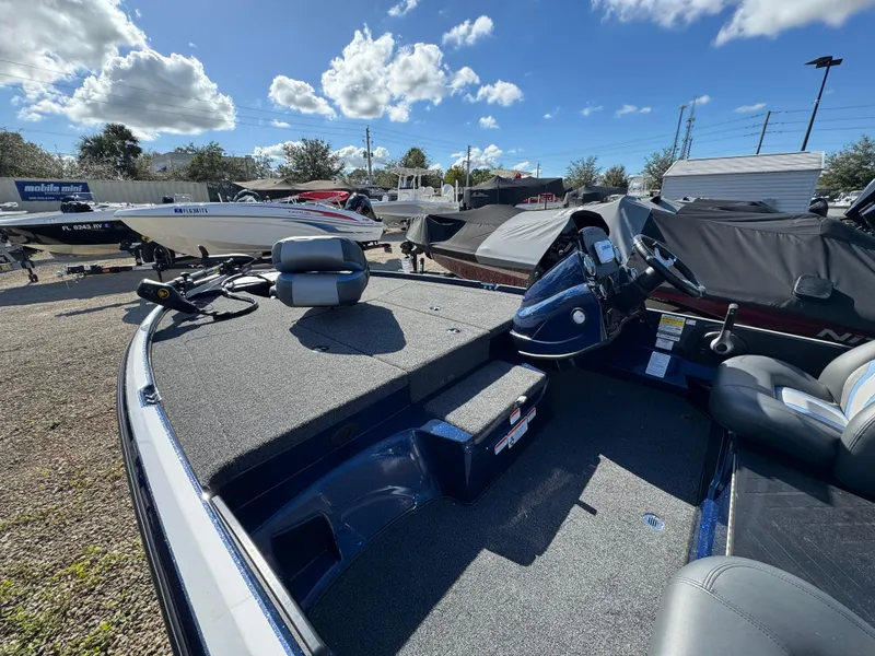 Slide: The Image of 2025 Nitro Z17 boat interior with steering console and seating under a sunny sky. - 4