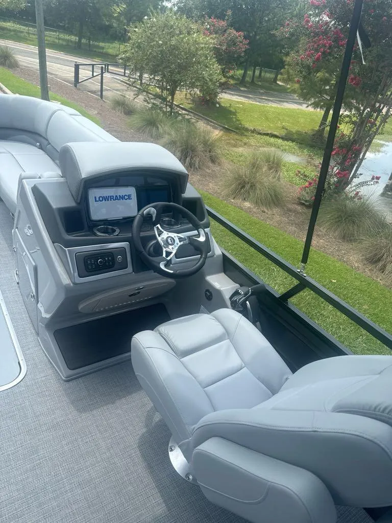 Slide: The Image of 2025 Regency 230 DL3 boat interior with modern steering and navigation system. - 5