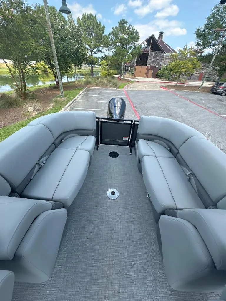 Slide: The Image of 2025 Regency 230 DL3 pontoon boat with spacious seating and modern design. - 6