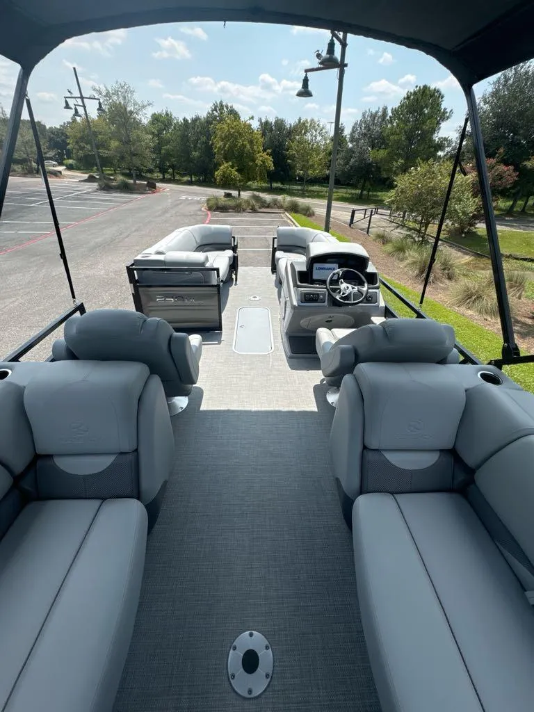 Slide: The Image of 2025 Regency 230 DL3 pontoon boat interior with plush seating and modern helm. - 8