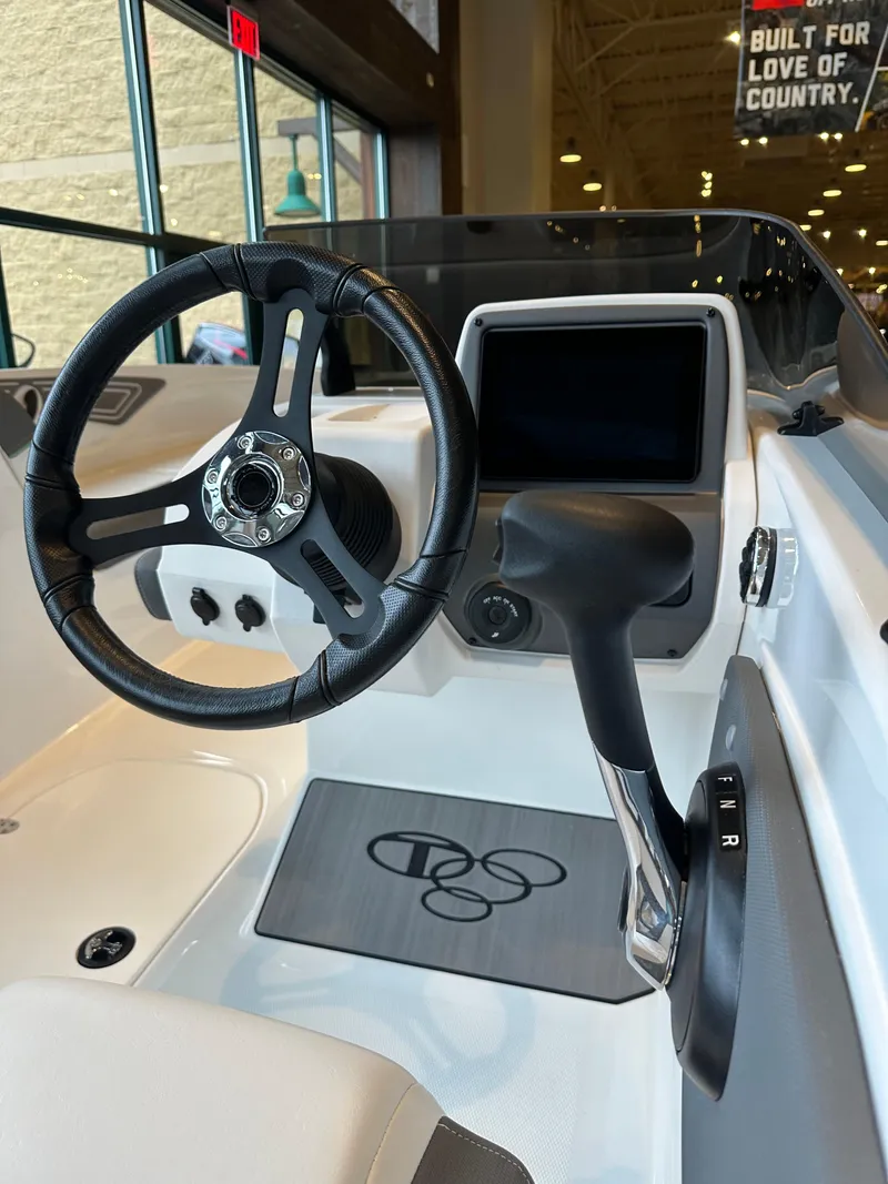 Slide: The Image of 2025 Tahoe T21 boat interior with steering wheel and control panel. - 3