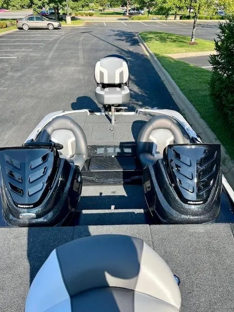 Slide: The Image of 2025 Nitro Z17 boat interior with dual seats and sleek design in a parking lot. - 4