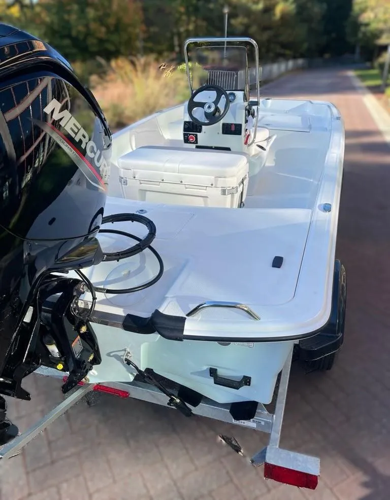 Slide: The Image of 2025 Mako Pro Skiff 17 CC boat with Mercury engine on a trailer. - 3