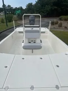 Slide: The Image of 2025 Mako Pro Skiff 19 CC boat, spacious deck, center console, outdoor setting. - 5