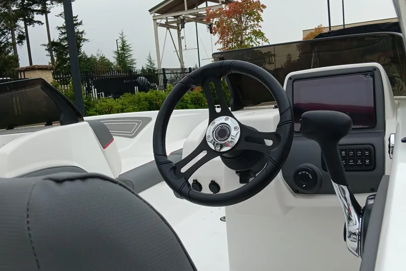 Slide: The Image of 2025 Tahoe T21 boat cockpit with steering wheel and control panel. - 2
