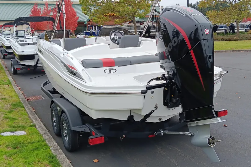 Slide: The Image of 2025 Tahoe T21 boat on trailer with powerful outboard motor, parked outdoors. - 3