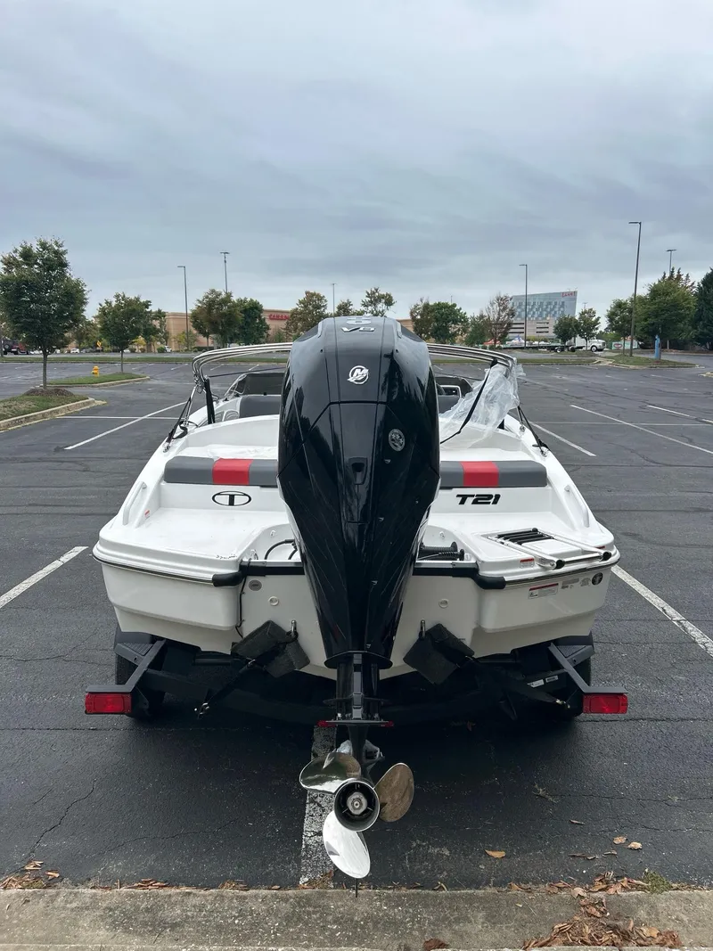 Slide: The Image of 2025 Tahoe T21 boat with outboard motor in a parking lot. - 3