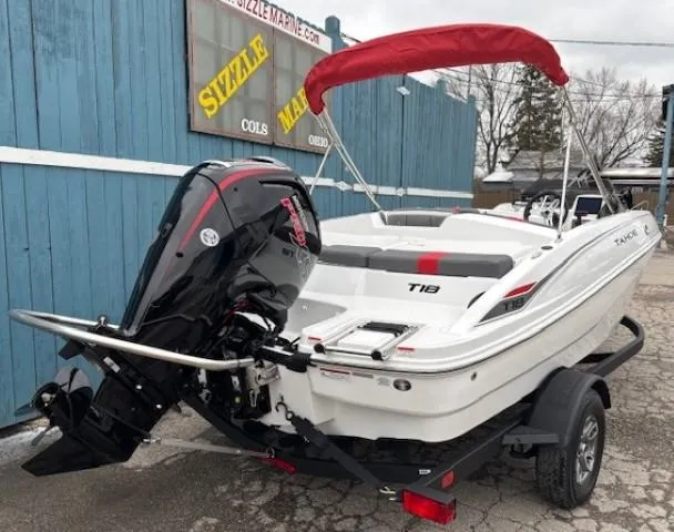 Slide: The Image of 2025 Tahoe T18 boat with red canopy and powerful outboard motor. - 2