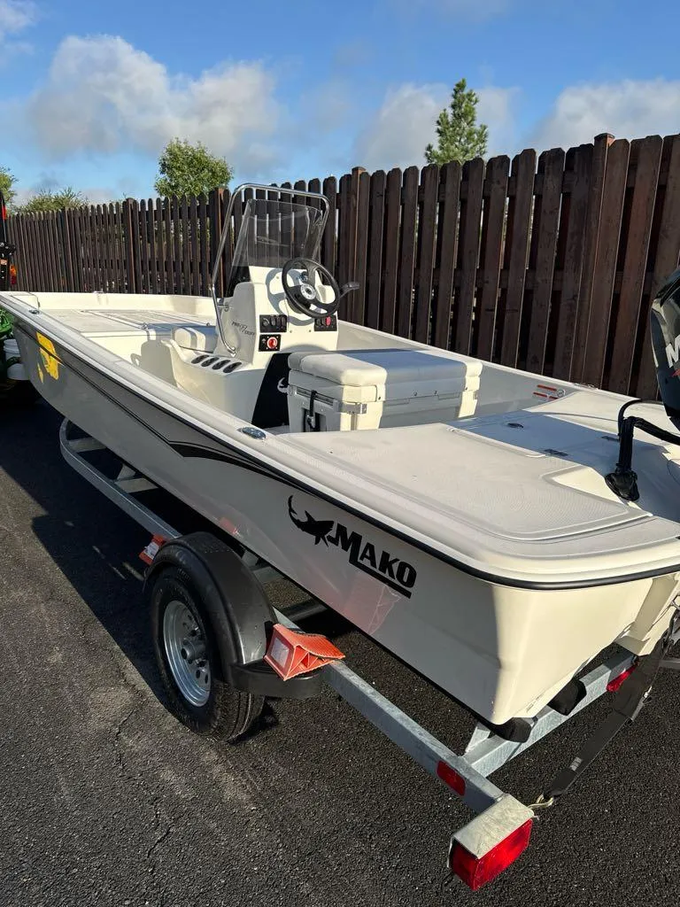 Slide: The Image of 2025 Mako Pro Skiff 17 CC boat on trailer, parked outdoors. - 0